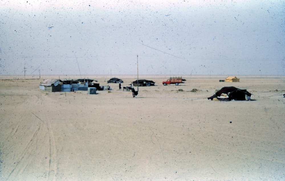 cars parked on white sand during daytime