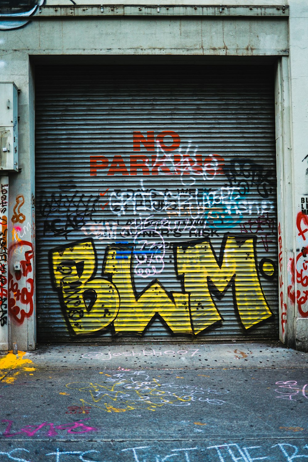 red white and yellow graffiti on gray wall