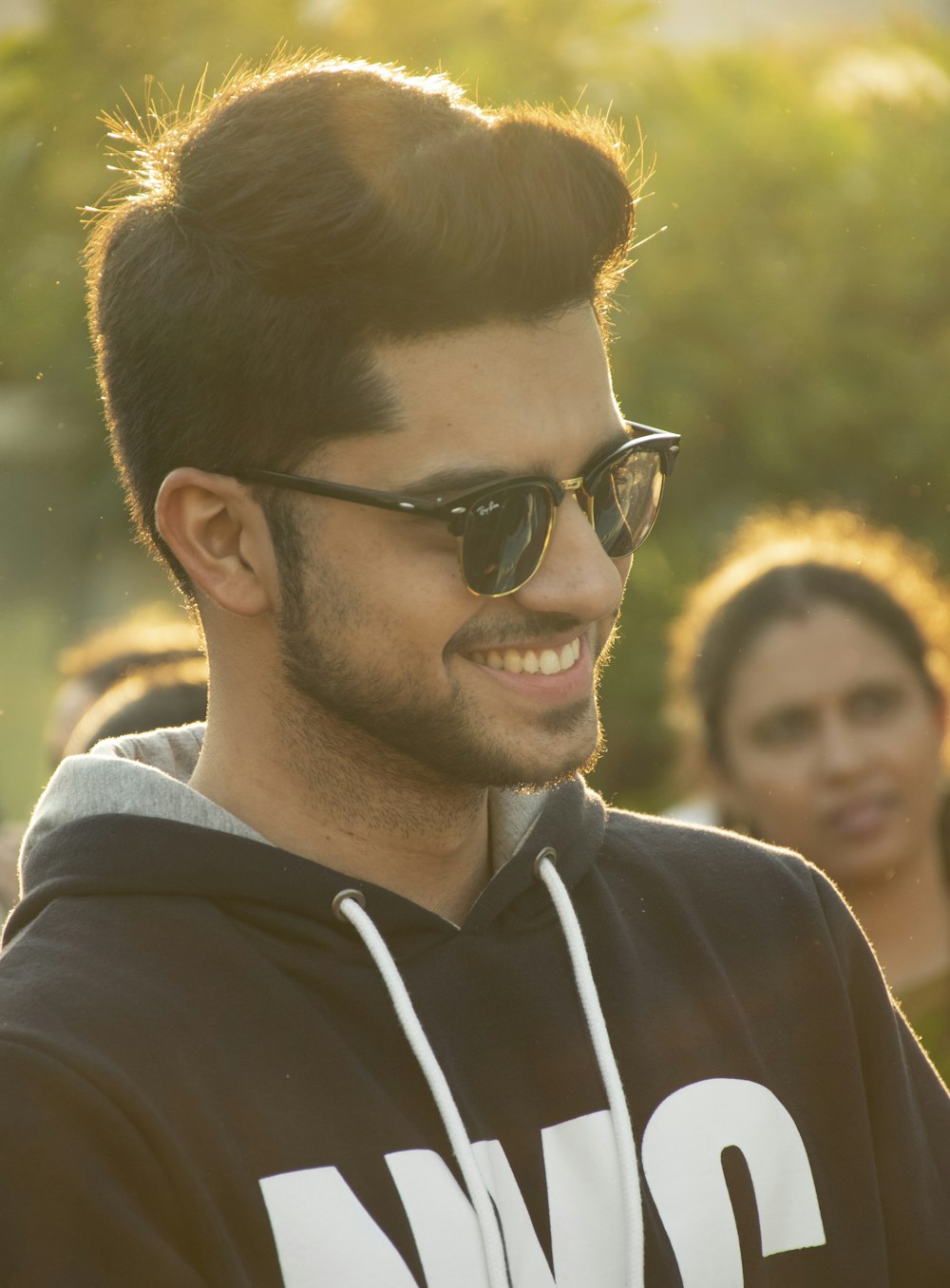 man in black hoodie wearing black sunglasses