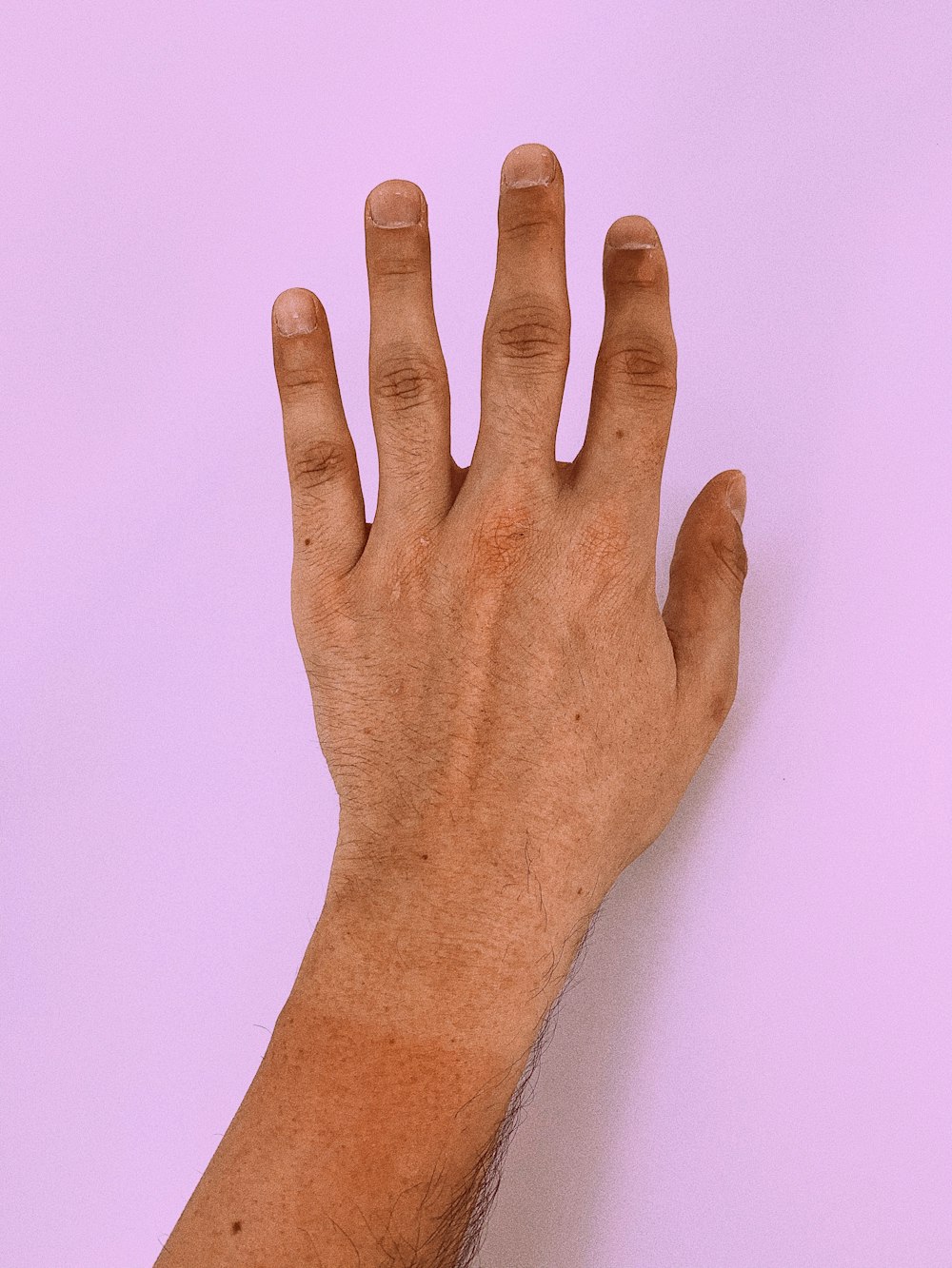 persons left hand on white surface