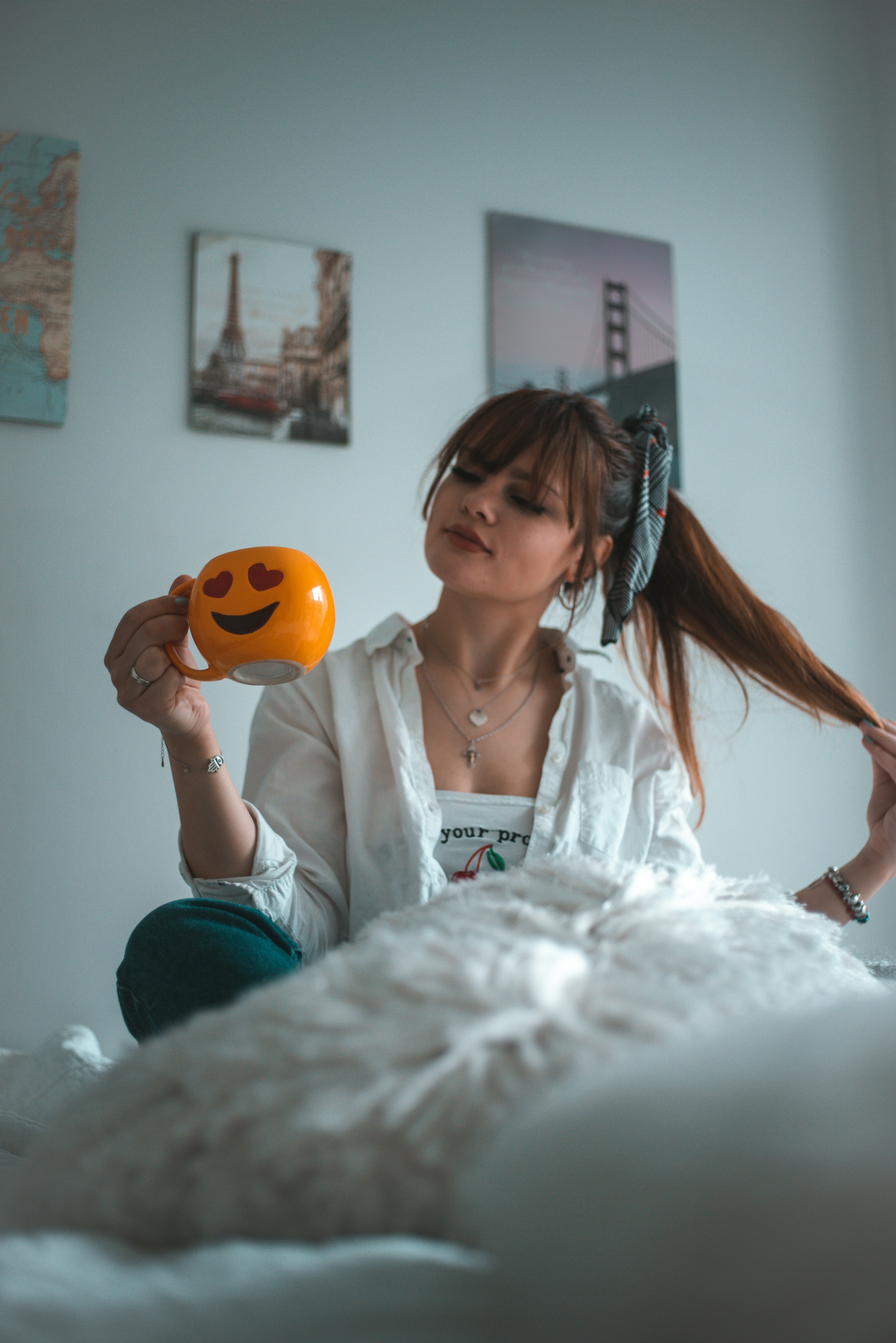 woman in white button up shirt holding orange balloon