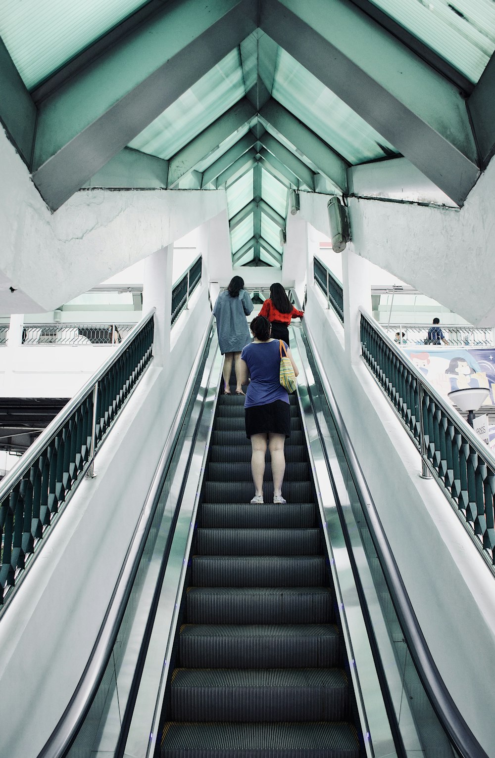 man in red and black jacket sitting on black and white staircase