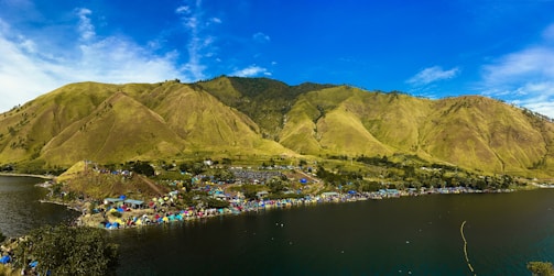A scenic view of a campsite surrounded by mountains.