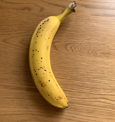 yellow banana fruit on brown wooden table