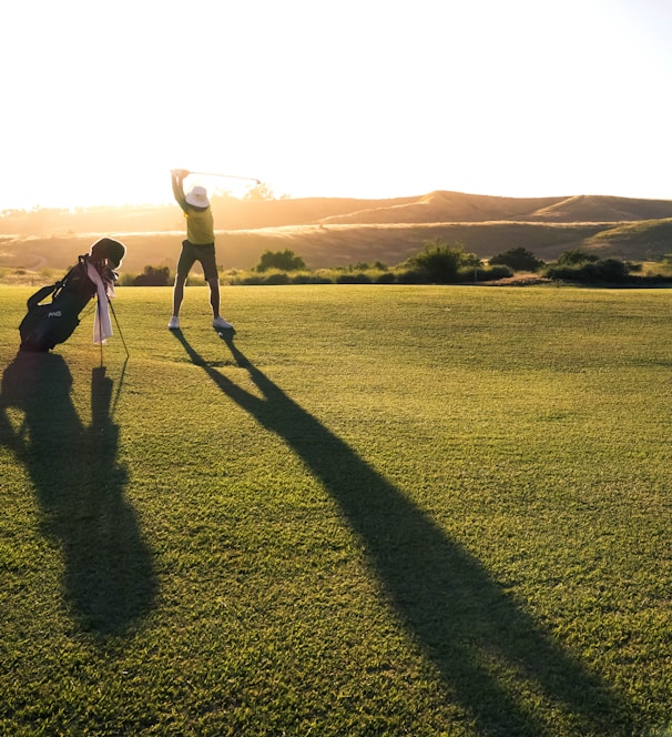 2 person walking on green grass field during daytime