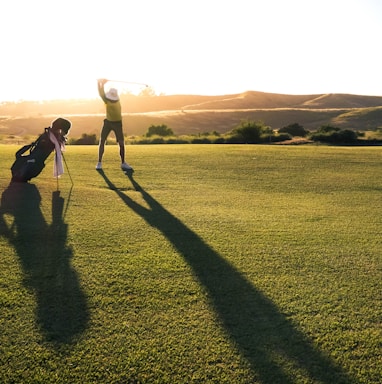 2 person walking on green grass field during daytime