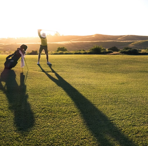 2 person walking on green grass field during daytime