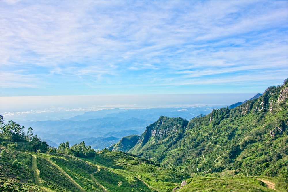 green mountains under white clouds during daytime