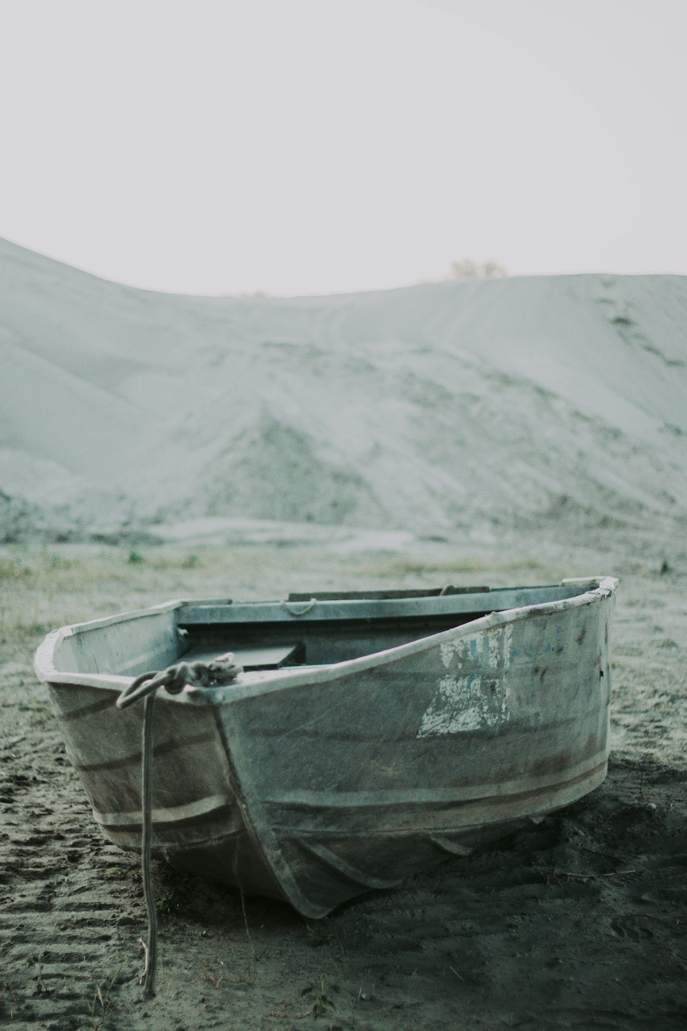 gray boat on brown soil