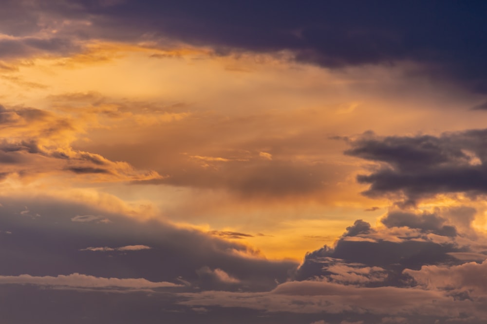 white clouds over mountains during daytime