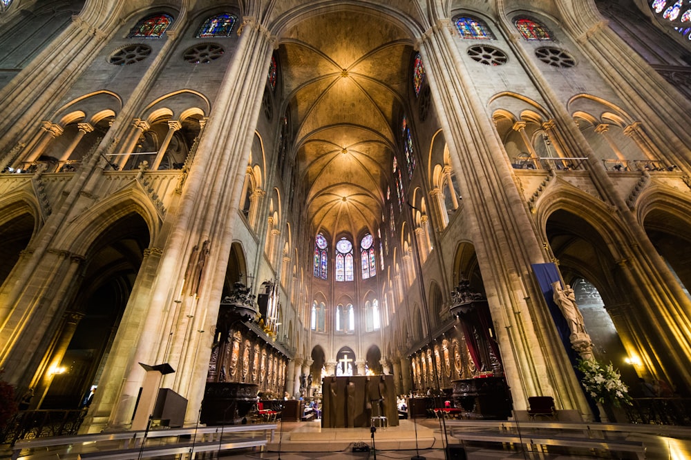 people walking inside white and brown cathedral