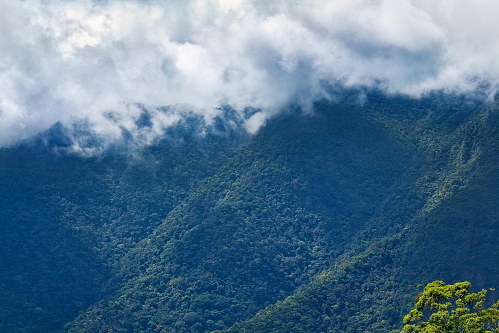 green mountain under white clouds during daytime