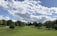 A serene golf course under a clear blue sky with lush green fairways.