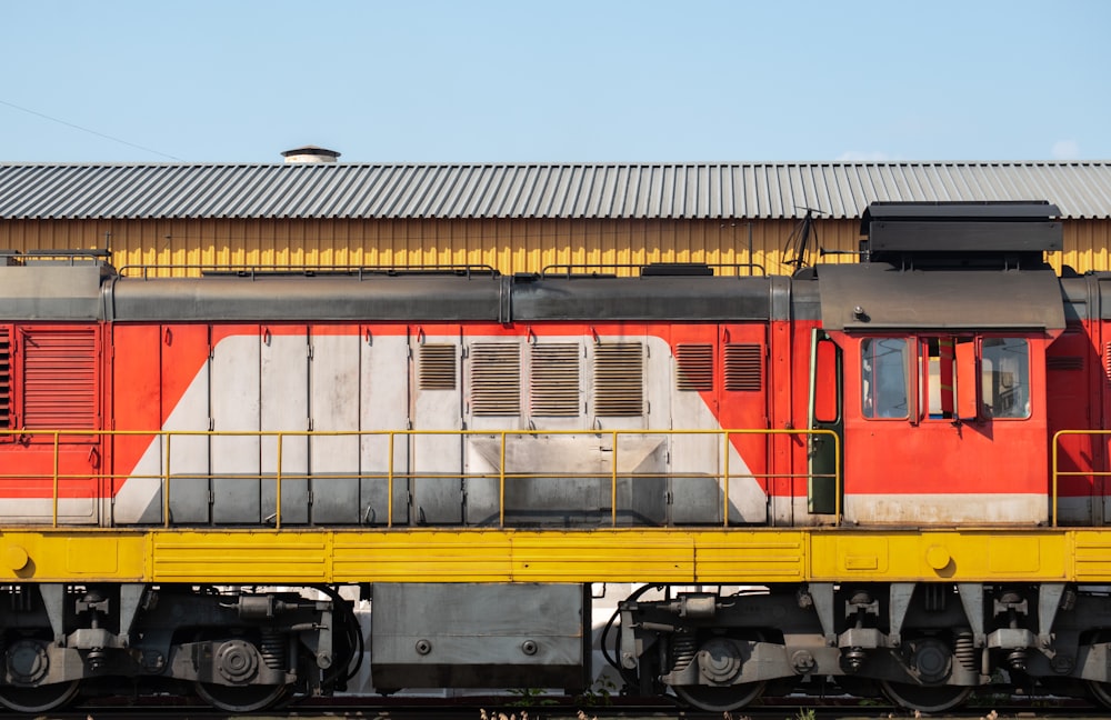 yellow and red train on rail tracks