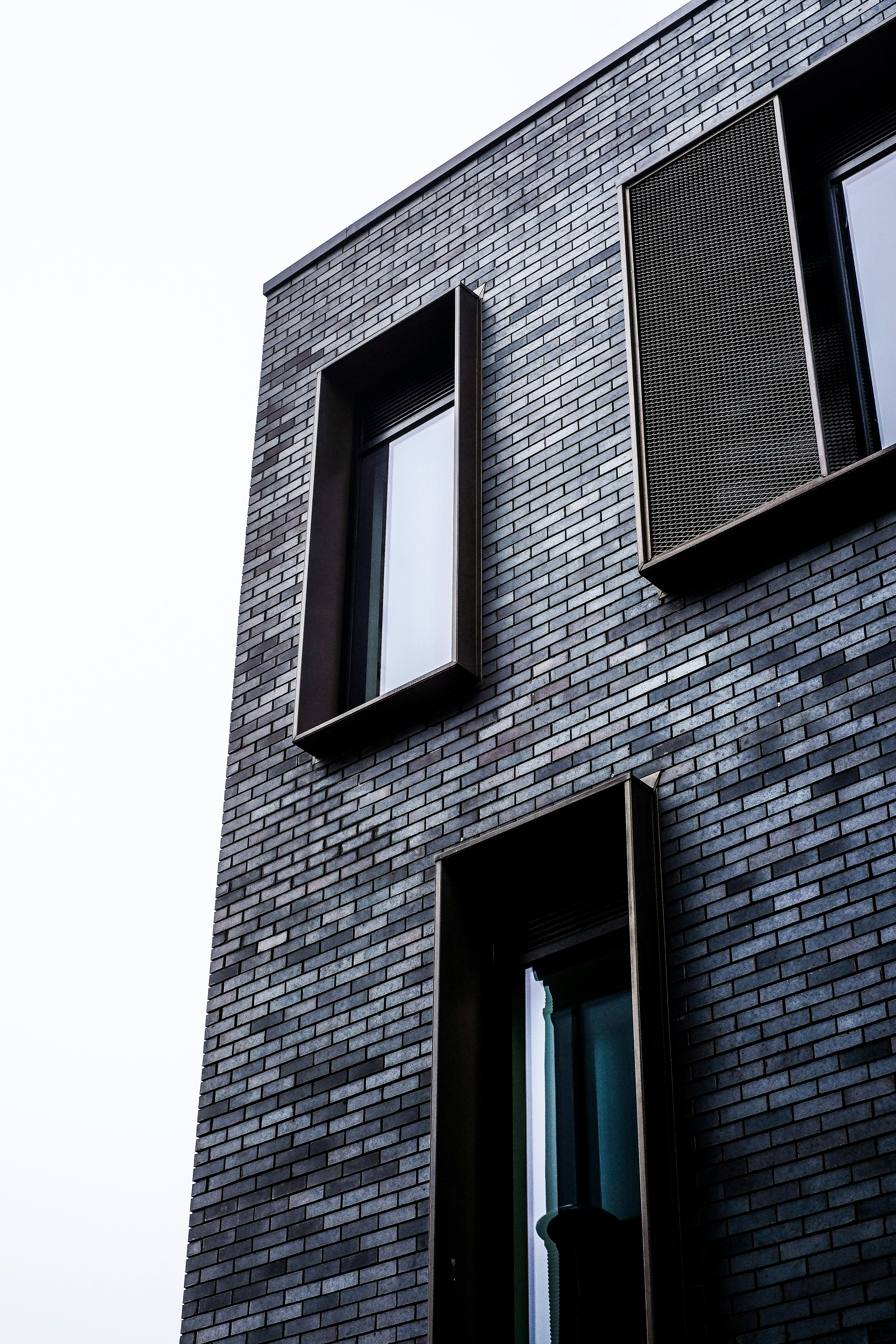 brown brick building with glass window