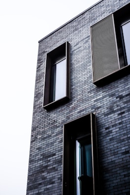 brown brick building with glass window
