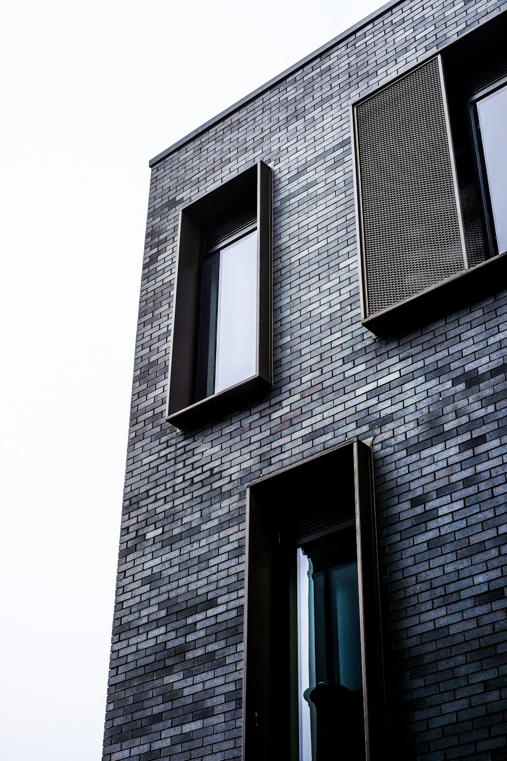 brown brick building with glass window