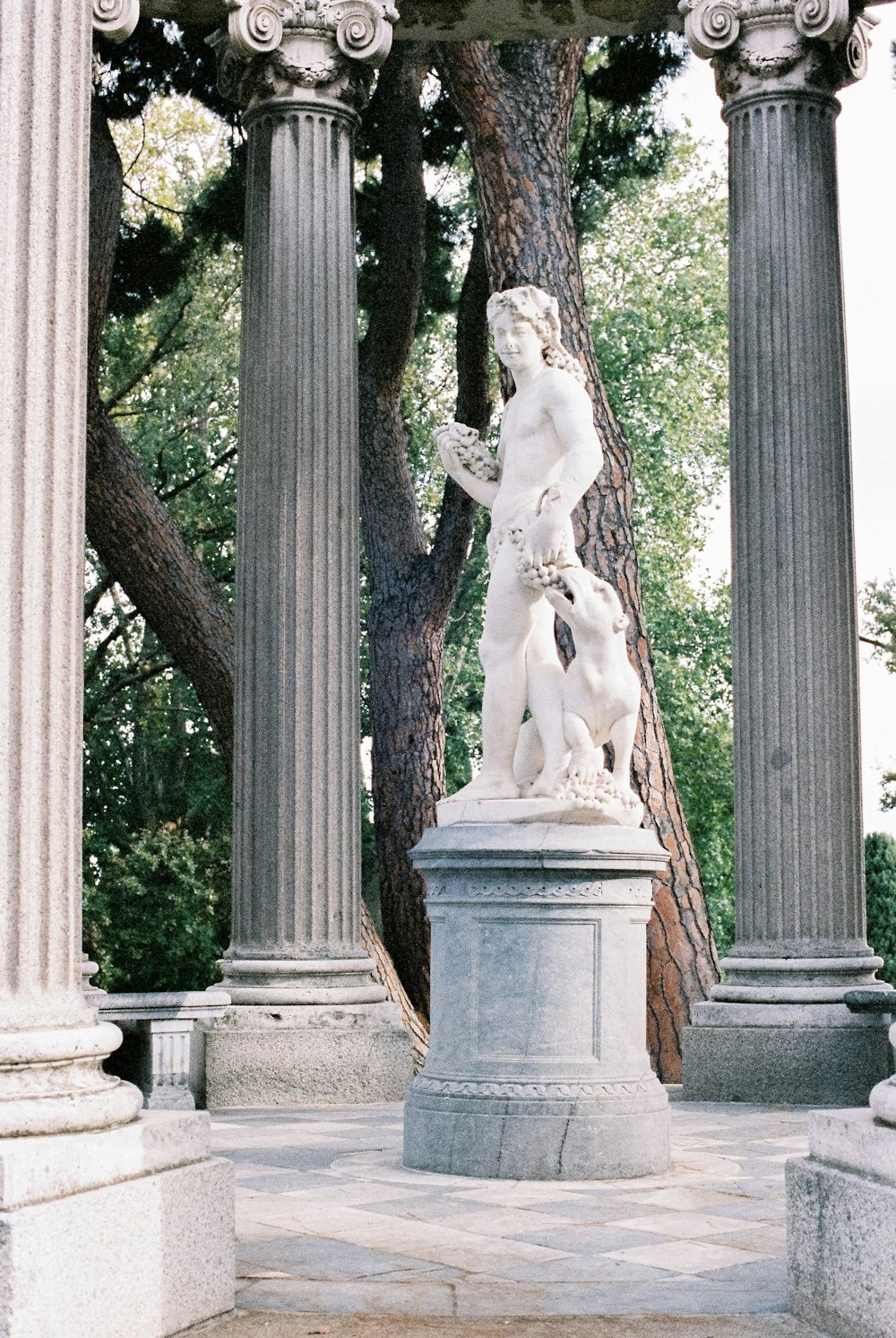 white concrete statue near brown tree during daytime