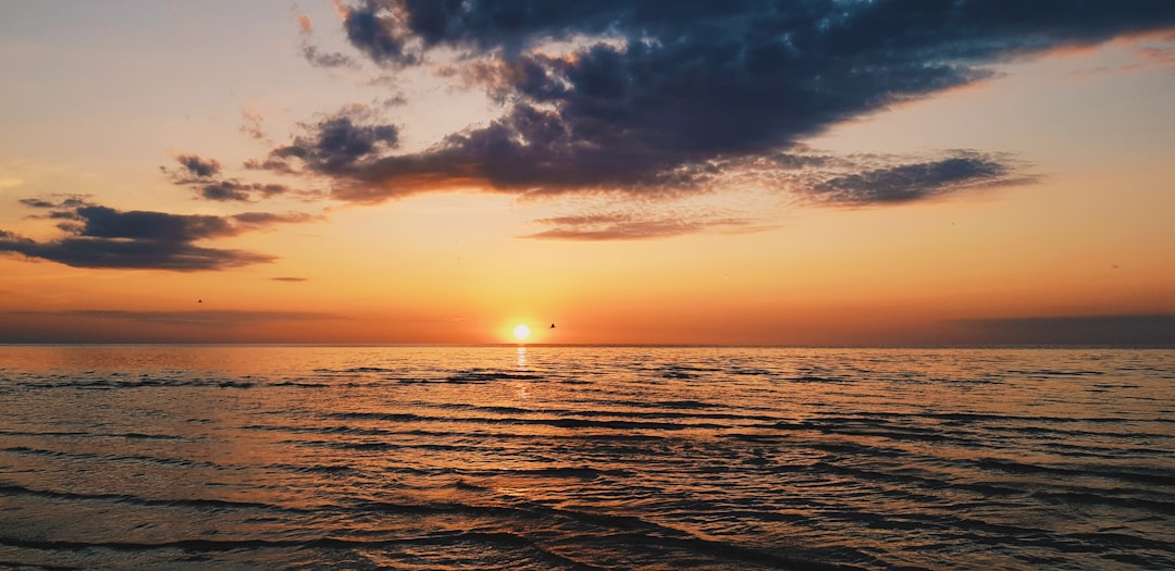 body of water during sunset