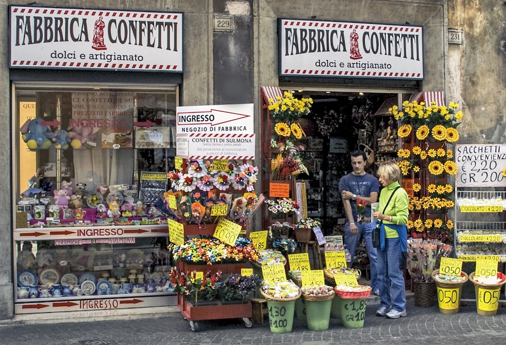 man in blue jacket standing in front of store