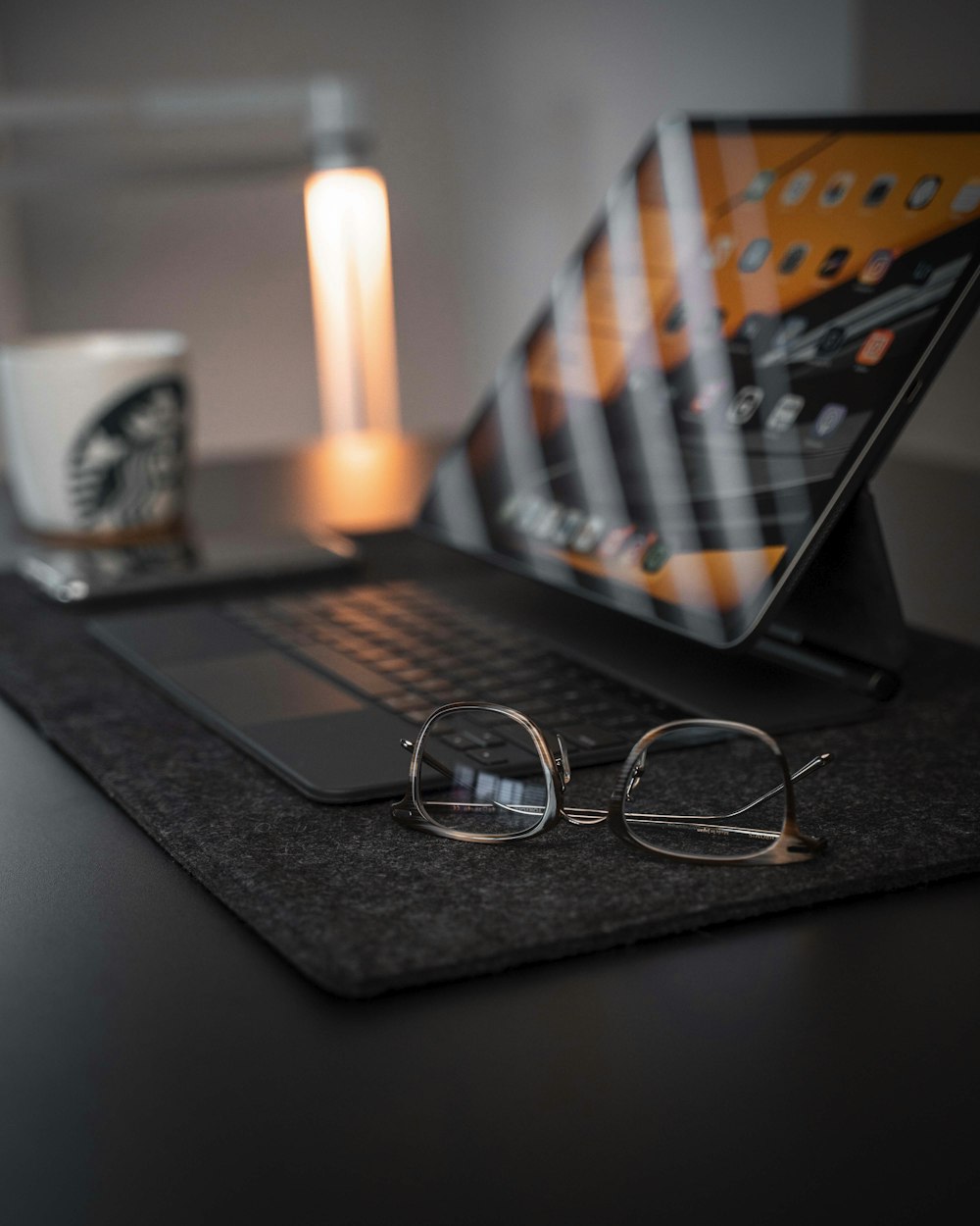 black framed eyeglasses on macbook pro