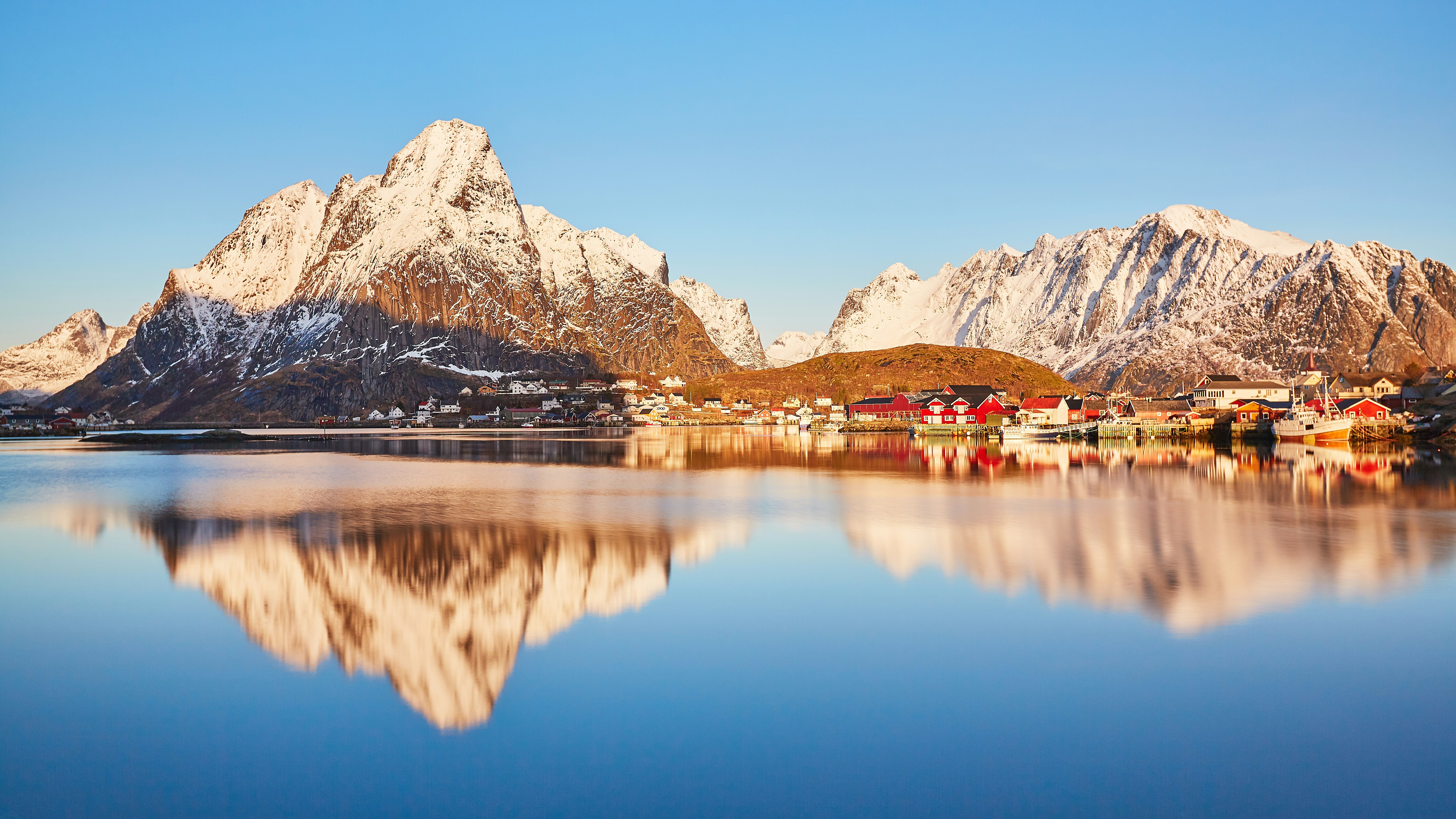 brown and white mountain near body of water during daytime, 