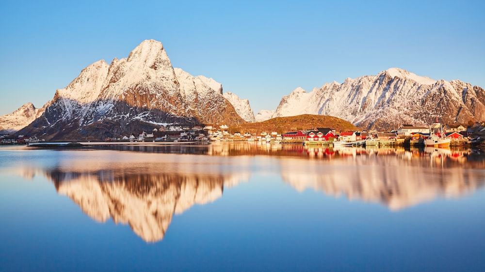 brown and white mountain near body of water during daytime