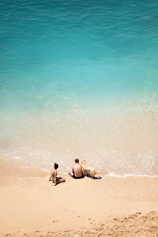 2 men sitting on beach during daytime in Kalkan Turkey