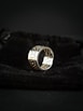 silver ring on black textile