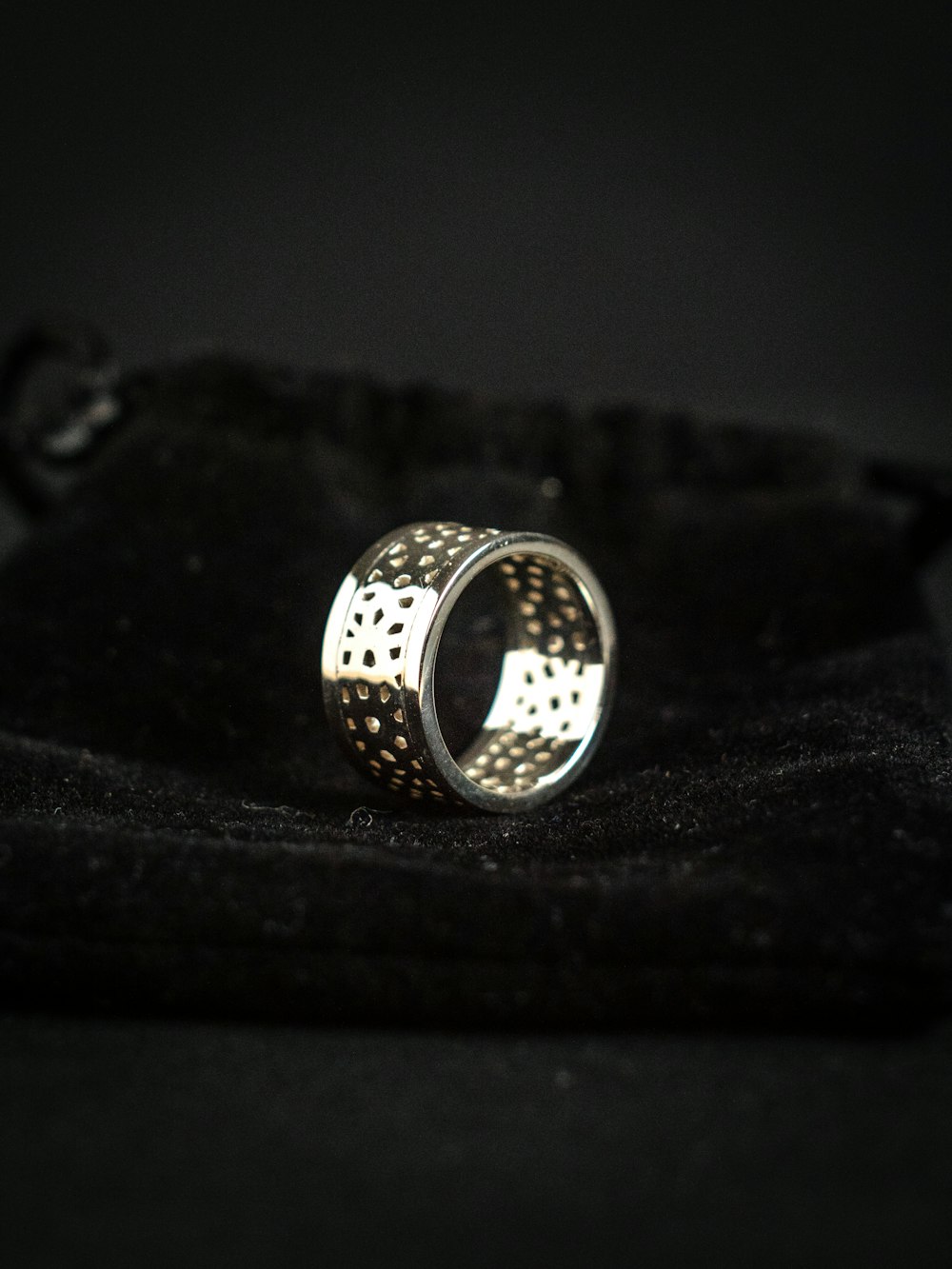 silver ring on black textile