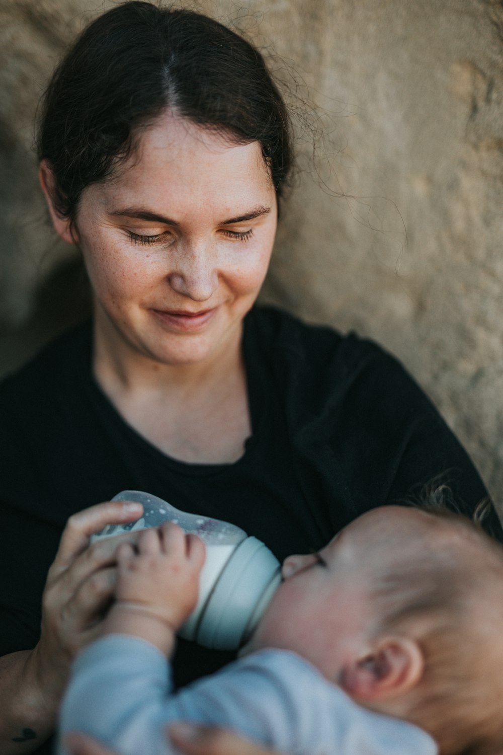 woman in black crew neck shirt holding baby