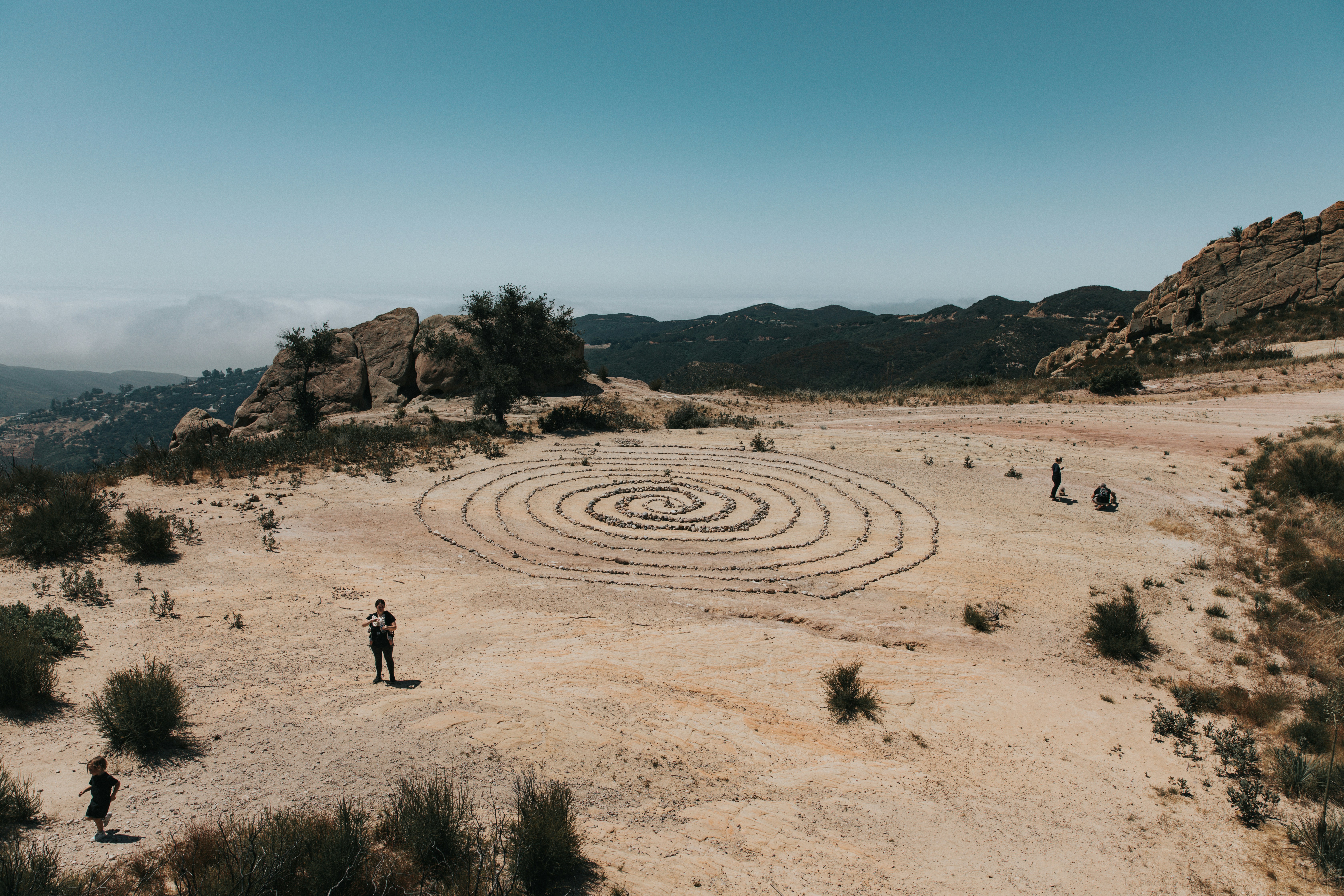 2 person walking on brown sand during daytime
