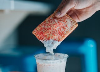 white plastic cup with white liquid and ice