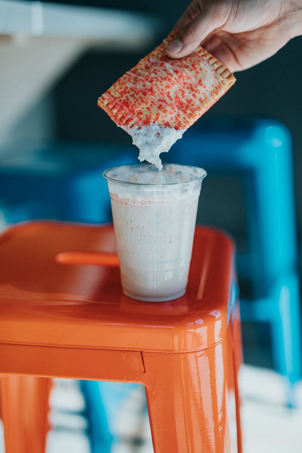 white plastic cup with white liquid and ice