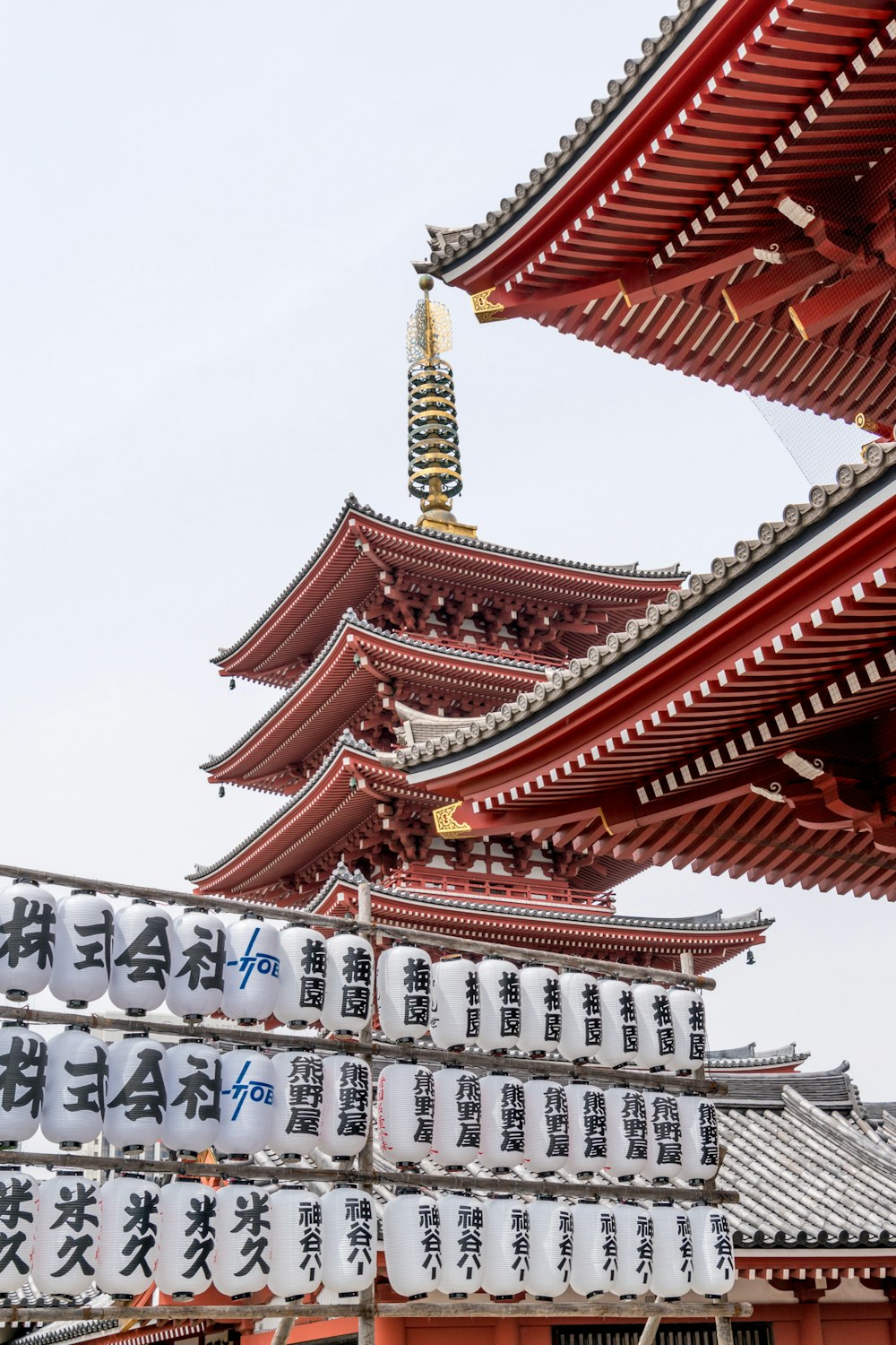 white and red temple under white sky during daytime