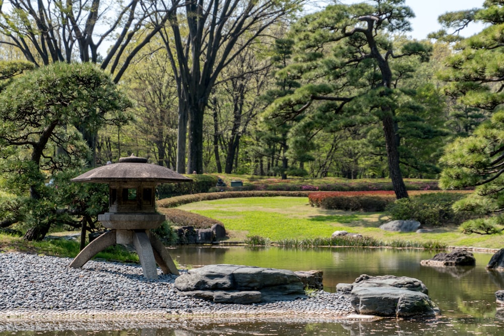 brown wooden gazebo near river during daytime