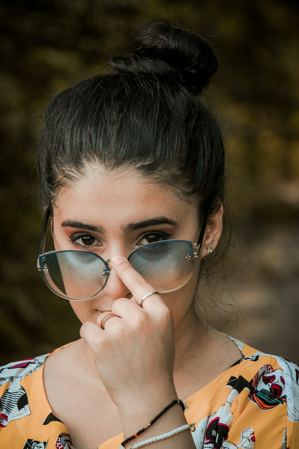 girl in white blue and red floral shirt wearing black framed eyeglasses