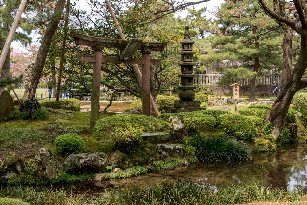 brown wooden gazebo on green grass field during daytime