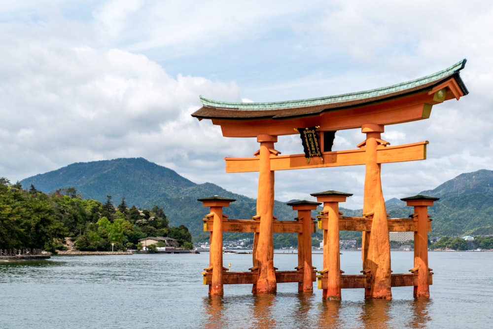 brown wooden arch on body of water during daytime