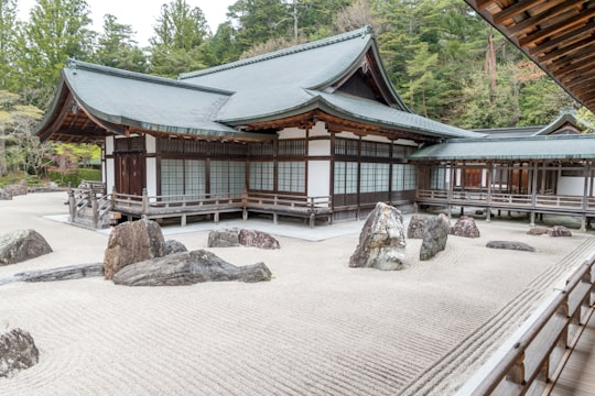 brown and white wooden house near green trees during daytime in Kongobuji Japan