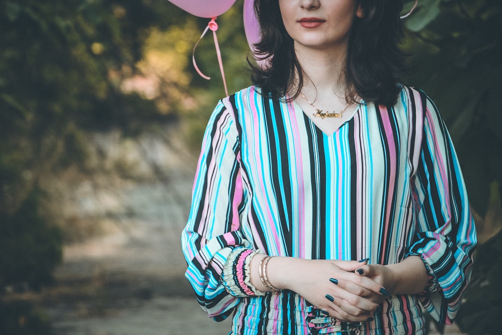 woman in white red and blue striped long sleeve shirt