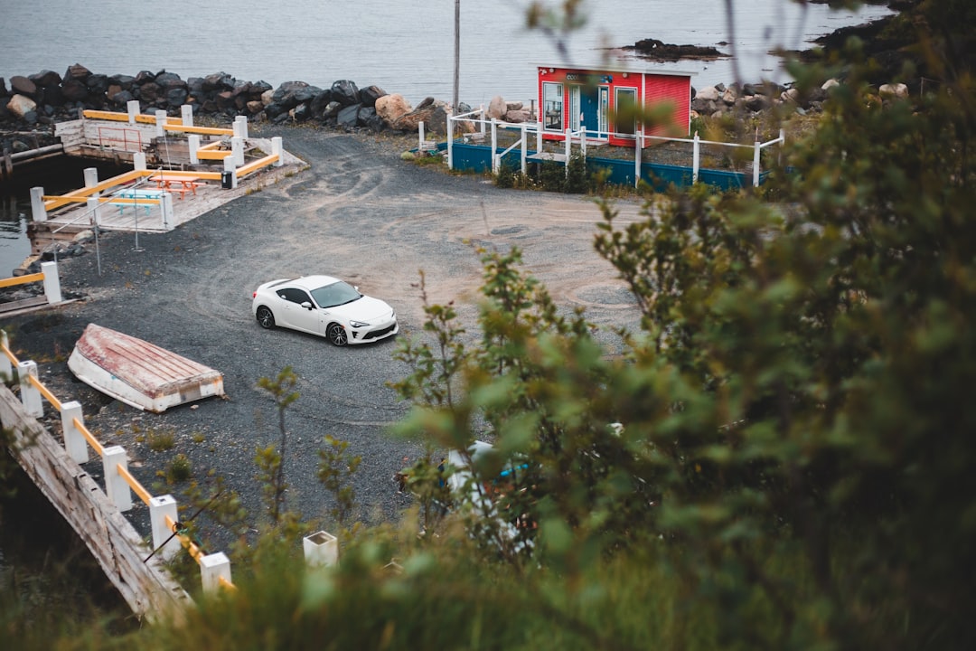 white coupe on dock during daytime