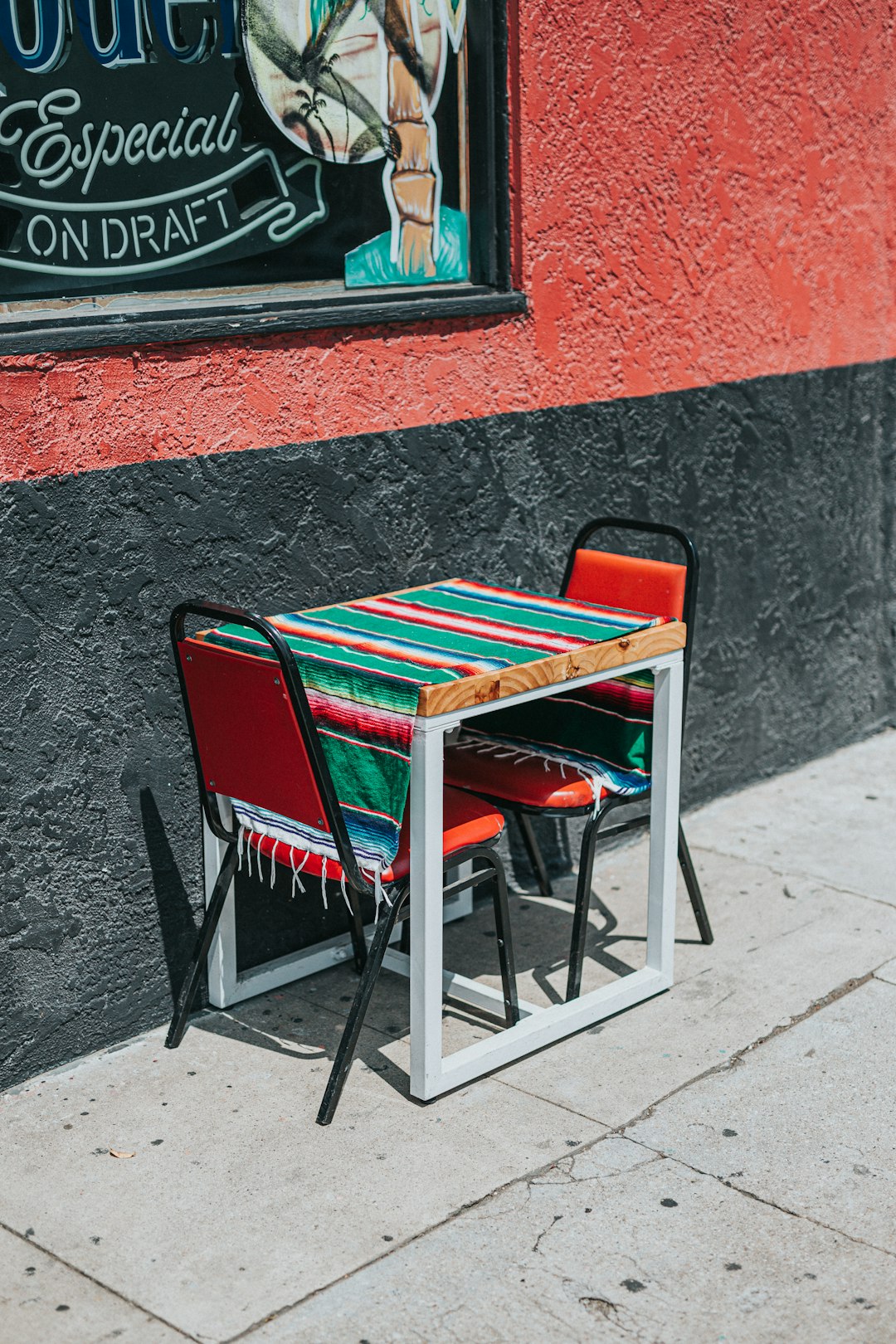 brown wooden chair beside red brick wall