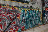 Close-up of colorful street art on a brick wall, showcasing intricate details.