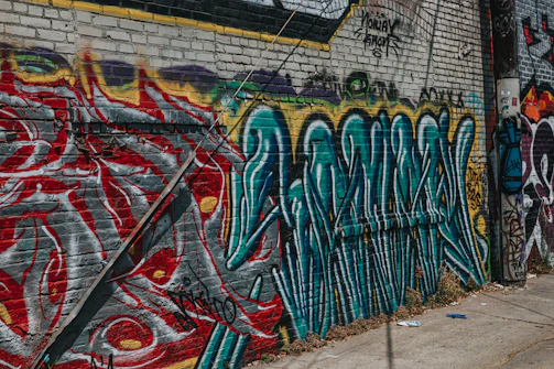 Close-up of colorful street art on a brick wall, showcasing intricate details.