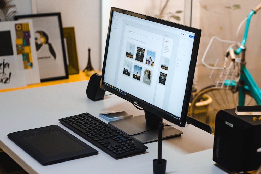 black flat screen computer monitor and black computer keyboard