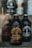 A dark, glass bottle labeled 'Stumptown Coffee Roasters Original Cold Brew Coffee' is prominently displayed in the foreground. Other similar bottles are blurred in the background, giving focus to the central bottle. The overall aesthetic is rustic and artisanal.