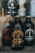 A dark, glass bottle labeled 'Stumptown Coffee Roasters Original Cold Brew Coffee' is prominently displayed in the foreground. Other similar bottles are blurred in the background, giving focus to the central bottle. The overall aesthetic is rustic and artisanal.