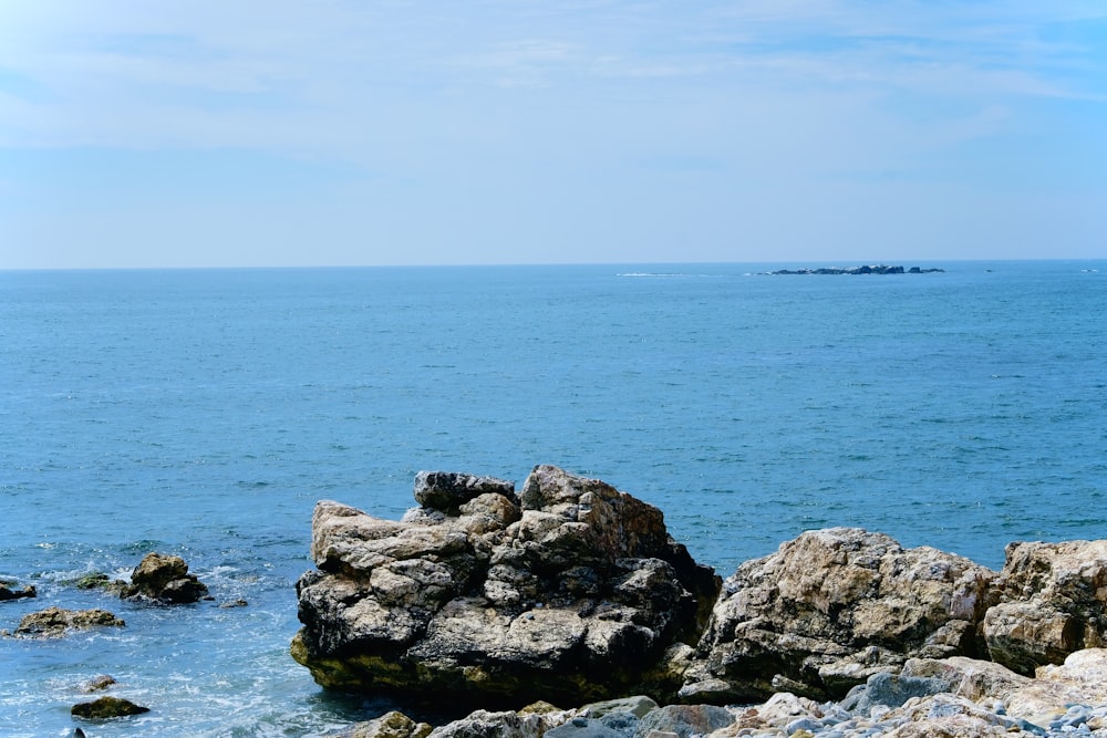 gray rocky shore under blue sky during daytime