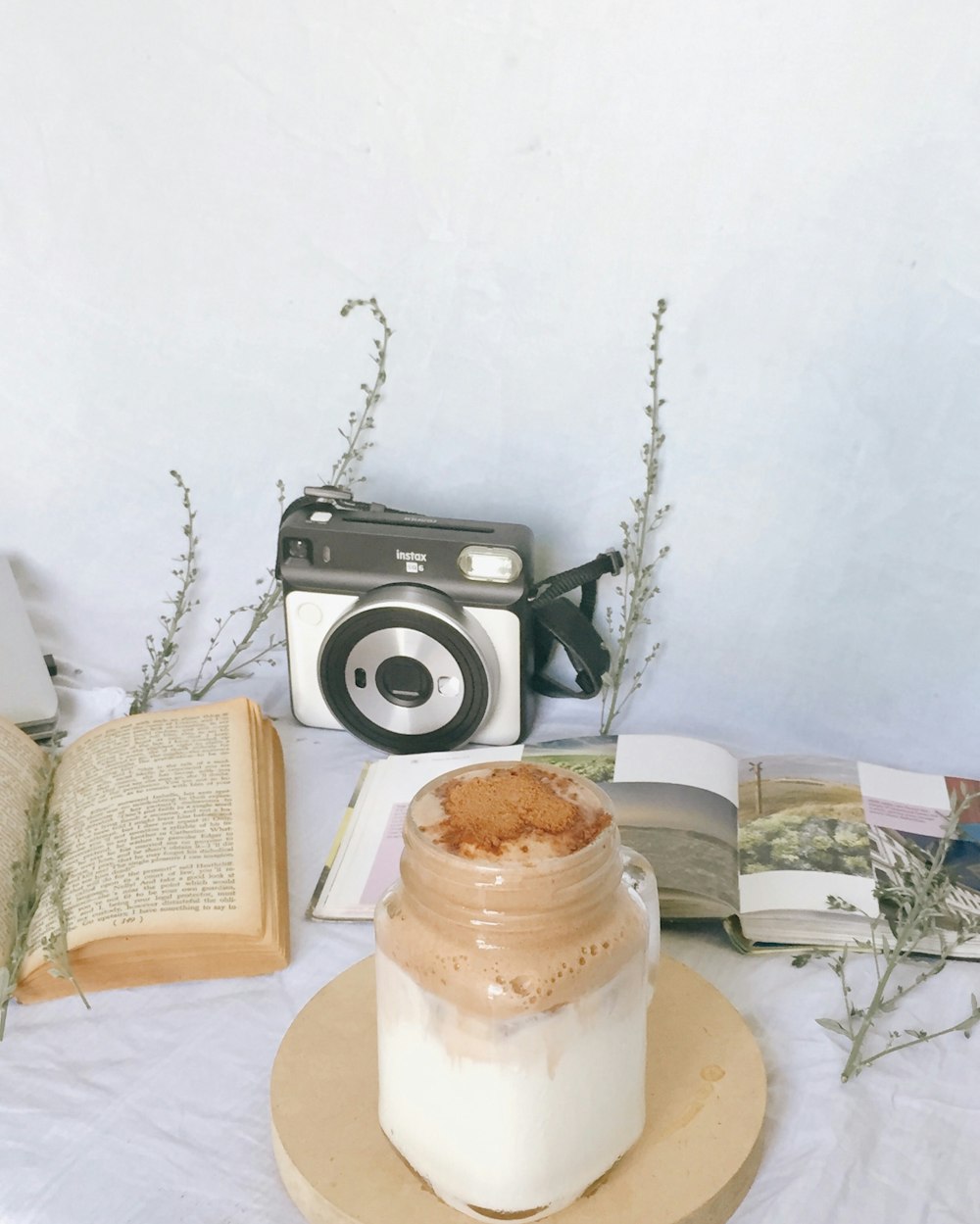 black and silver camera beside white and brown cake